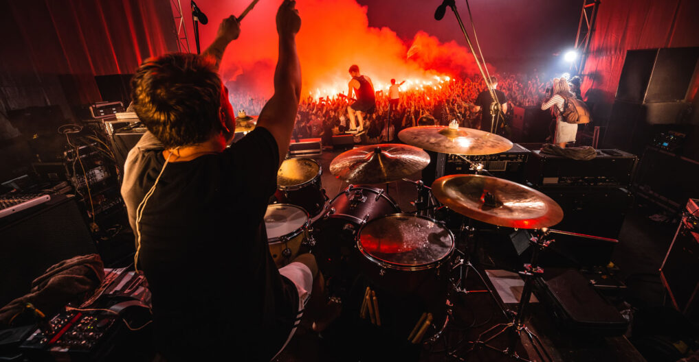 Drummer on stage. silhouette of music band in action on music stage. popular music rock band performs on stage.